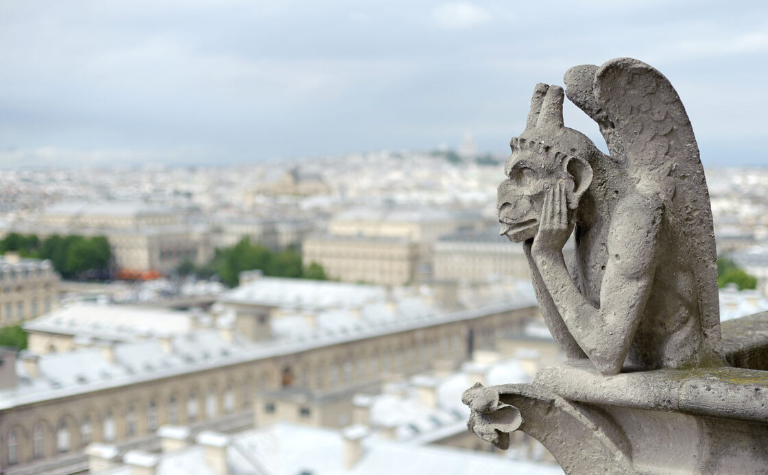 A bored-looking gargoyle atop Notre Dame Cathedral in Paris