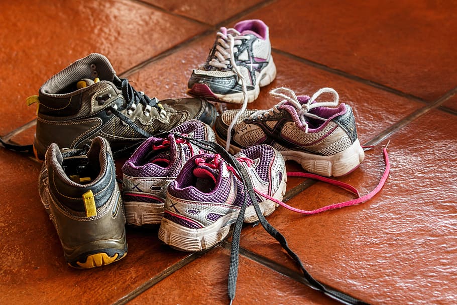 Half a dozen children’s shoes on the floor