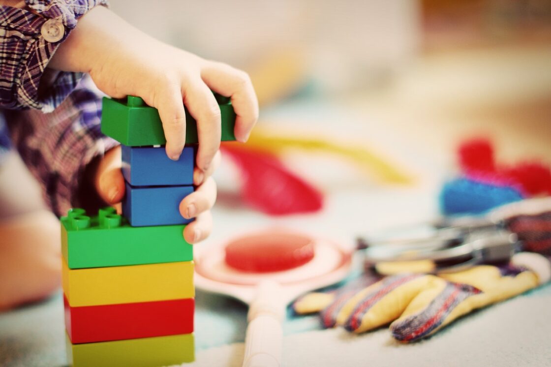 A child building with multicoloured blocks