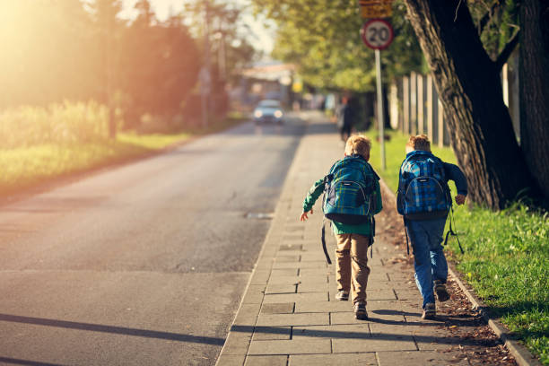 Two children running down a footpath