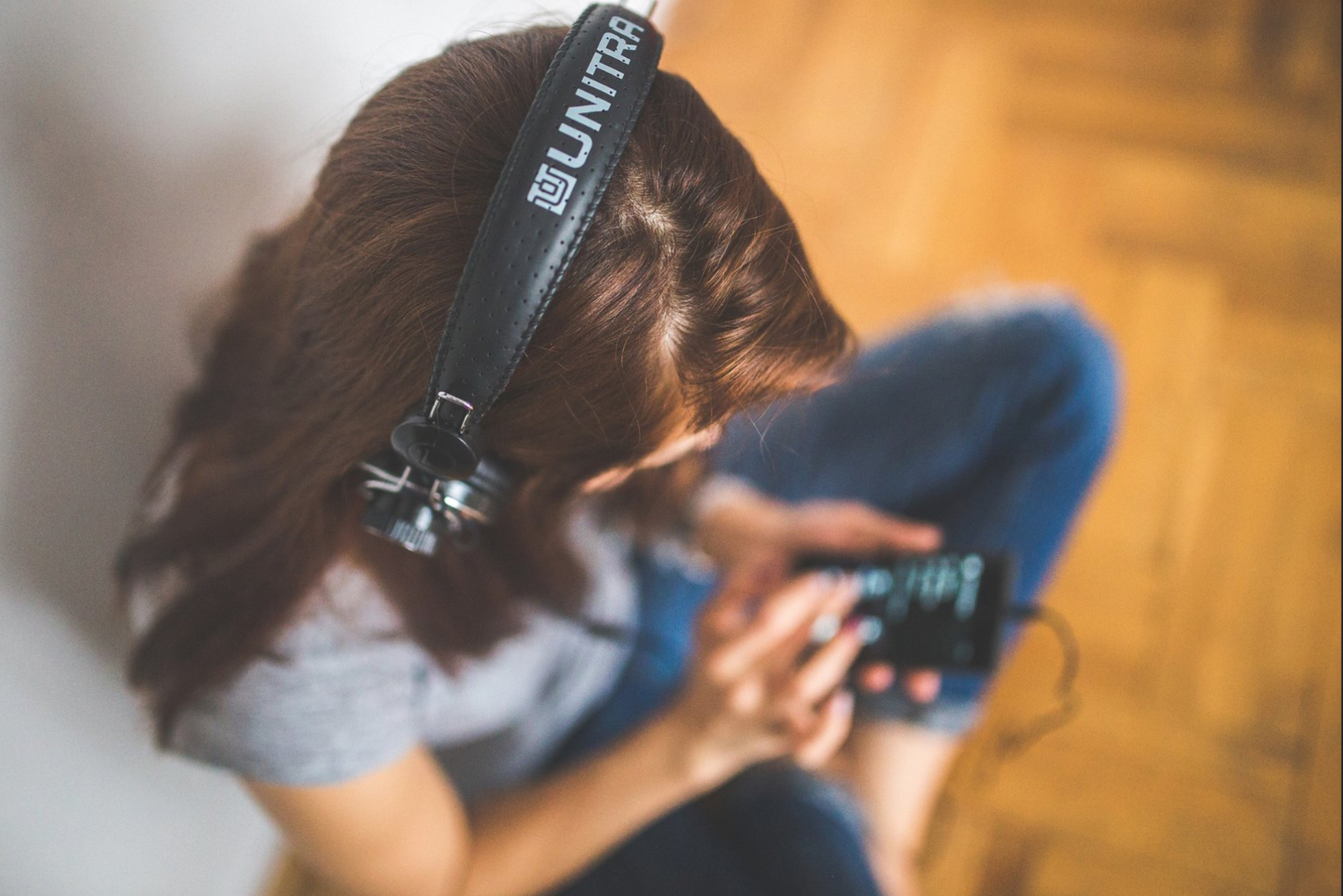 Arial view of a young woman wearing headphones